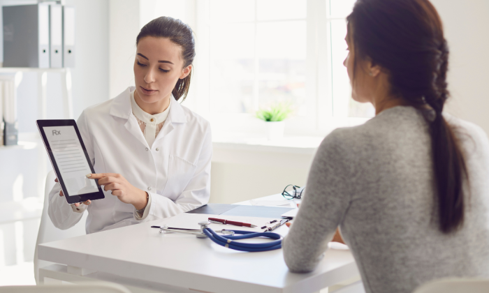 docteur qui montre un bilan dentaire à la patiente ménopausée